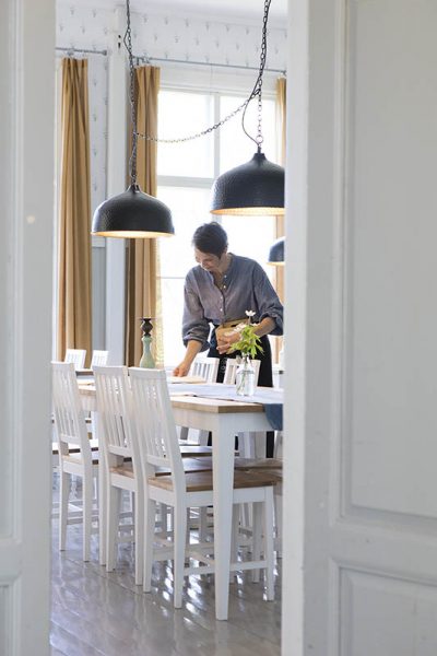 Outi Fagerlund fixing the dinning room in Hotel Hyppeis