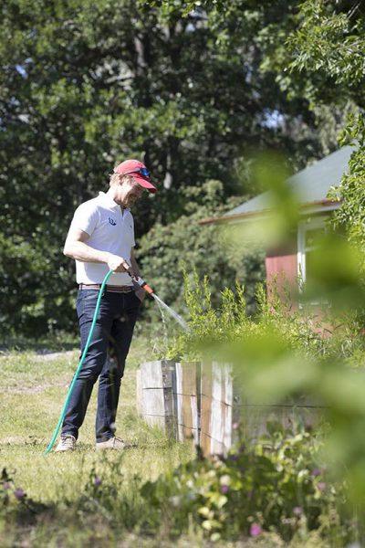 Sam Fagerlund watering the garden