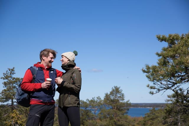 A couple on the top of the hill looking at each other